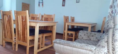 a living room with chairs and a table and a couch at Royal Mount Guest House Ladakh by LexStays in Leh
