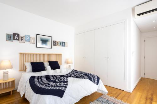 a white bedroom with a large bed and white walls at Stylish 3-Bedroom Villa Haven with a Private Pool in Albufeira