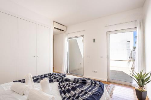 a bedroom with a bed and a large window at Stylish 3-Bedroom Villa Haven with a Private Pool in Albufeira