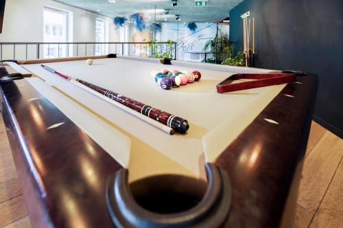 a pool table with two cue balls on it at Maverick Central Market in Budapest