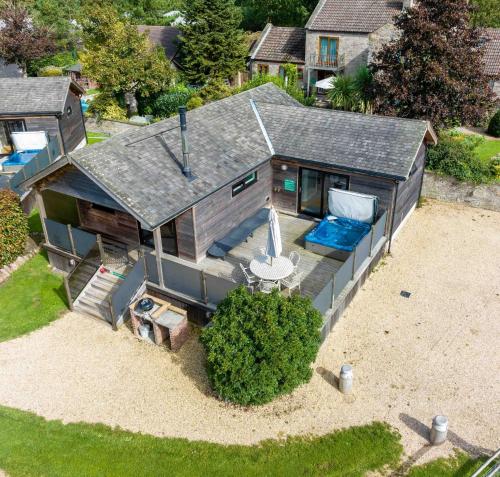 an overhead view of a house with a pool and a beach at Tor Farm Lodges - Private Hot Tubs, Shared Seasonal Outdoor Pool, Dog Friendly in Cheddar