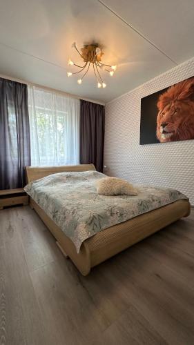 a bedroom with a bed with a picture of a lion on the wall at Apartment on Karja in Narva-Jõesuu