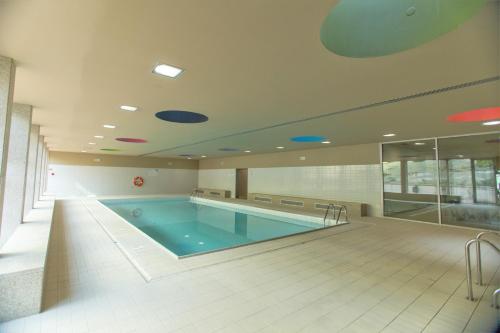 a large swimming pool in a large building at Afurada premium apartment by Porto City Hosts in Vila Nova de Gaia
