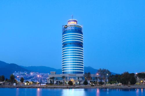 a tall blue building with lights on top of it at Wyndham Grand Izmir Ozdilek Thermal & Spa in Izmir