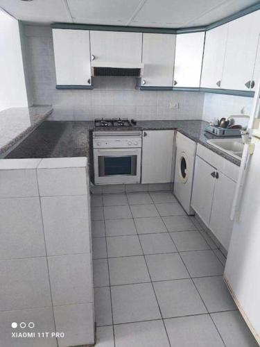 a white kitchen with a stove and a sink at Chalet Full Sea View in Jounieh in Ed Dkârîne