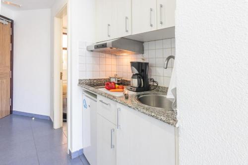 a kitchen with a sink and a counter top at Beachfront Apartment Playa del Cura 3 by VillaGranCanaria in Playa del Cura