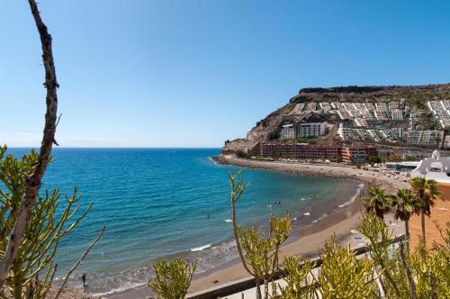 a view of a beach and the ocean at Beachfront Apartment Playa del Cura 3 by VillaGranCanaria in Playa del Cura