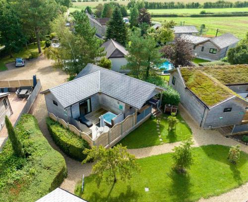 an aerial view of a house with a grass roof at Tor Farm Lodges - Private Hot Tubs, Shared Seasonal Outdoor Pool, Dog Friendly in Cheddar