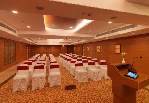 a room with rows of tables and chairs in it at Goldfinch Retreat Bangalore in Devanahalli-Bangalore