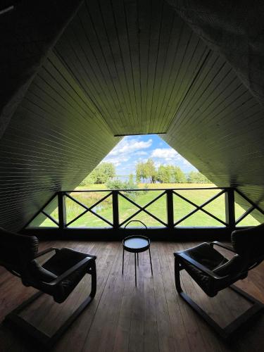 a room with two chairs and a table and a window at Marga Pieva in Inturkė