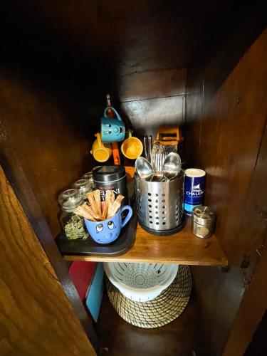 a shelf with food and pots and pans on it at Marga Pieva in Inturkė
