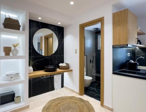 a bathroom with a sink and a toilet and a mirror at Keti Kapri in Plaka