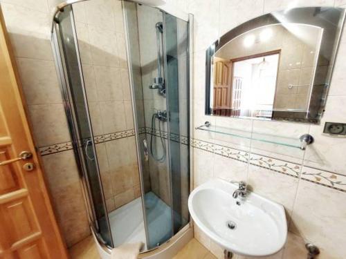 a bathroom with a shower and a sink and a mirror at Pokoje gościnne Zawoja Centrum Henryk Hadka in Zawoja
