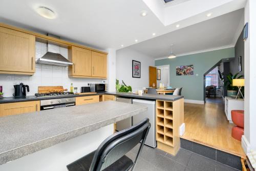 a kitchen with wooden cabinets and a counter top at No24Sandbach - Exclusive House - Pet Friendly in Sandbach