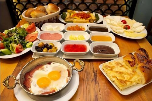 a table with plates of food and eggs and other dishes at Royal Suite Hotel in Istanbul