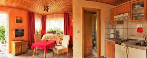 a kitchen with a table with a red table cloth at Ferienhaus in der Altstadt in Barth