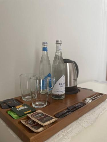 a wooden tray with bottles and glasses on a table at Ametist Hotel Complex in Samarkand