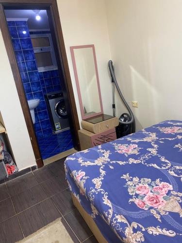 a bedroom with a bed and a bathroom with a mirror at Porto Sharm Pool View VIP-Service in Sharm El Sheikh