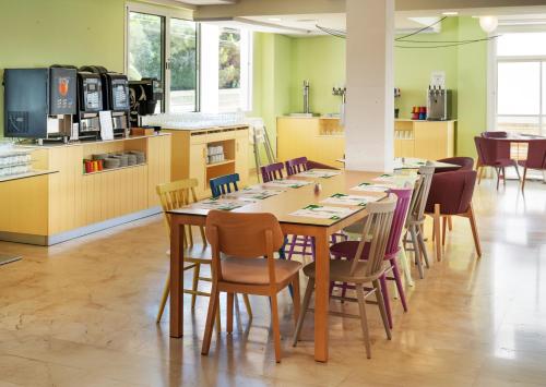 a long table and chairs in a room at Hotel Calimera Fido Gardens in Cala d´Or