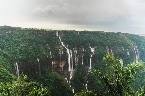 a waterfall in the middle of a mountain at Polo Cherrapunjee Resort in Cherrapunji