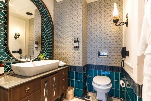 a bathroom with a sink and a toilet and a mirror at Polo Cherrapunjee Resort in Cherrapunji