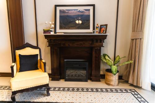 a living room with a fireplace with a tv above it at Polo Cherrapunjee Resort in Cherrapunji