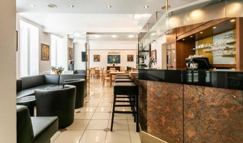 a bar in a restaurant with chairs and tables at Ametyst Hotel Praha in Prague