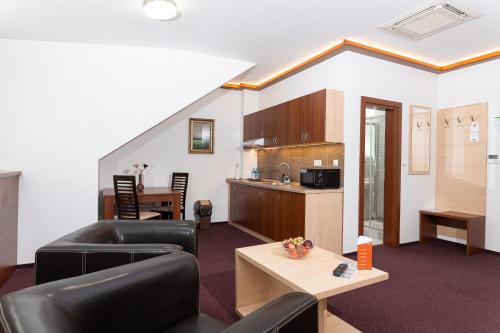 a living room with a couch and a table at SISI Pension in Púchov