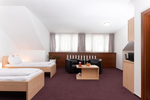 a hotel room with a bed and a couch at SISI Pension in Púchov