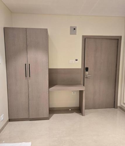 an empty room with a bench and a locker at Western Hotel in Chandrapur