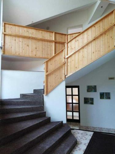 a set of stairs in a building with a stair case at Egyszerű és nagyszerű Hostel in Gheorgheni