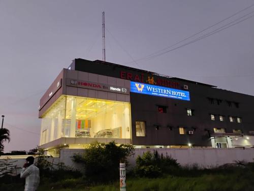 a building with a sign on the side of it at Western Hotel in Chandrapur