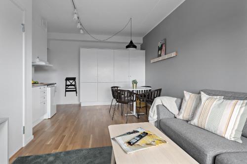 a living room with a couch and a table at Forenom Hotels & Apartments Kista in Stockholm