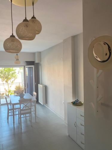 a kitchen and dining room with a table and chairs at Blue Eye in Amfilochía
