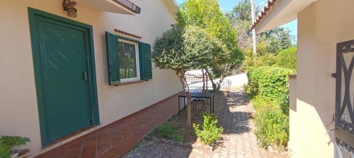 a green door on the side of a house at Moon Ash - Cenere di Luna in Poggio Moiano