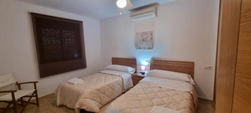 a bedroom with two beds and a chalkboard on the wall at Casas Rurales Racha Rachel, Zarza la Mayor in Zarza la Mayor