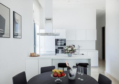 a kitchen with a table with a bowl of fruit on it at Nicosia Central Park Residences in Nicosia