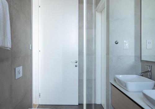 a bathroom with a sink and a shower backdoor at Nicosia Central Park Residences in Nicosia