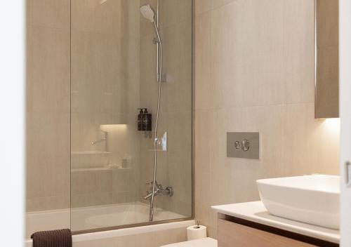 a bathroom with a shower and a sink at Nicosia Central Park Residences in Nicosia