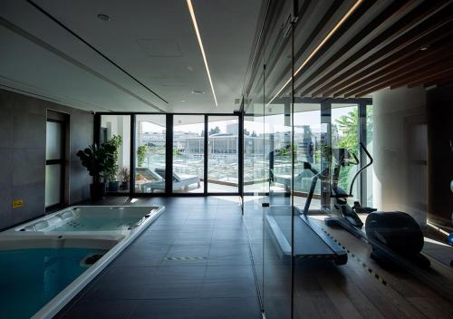 a large bathroom with a tub and a swimming pool at Nicosia Central Park Residences in Nicosia