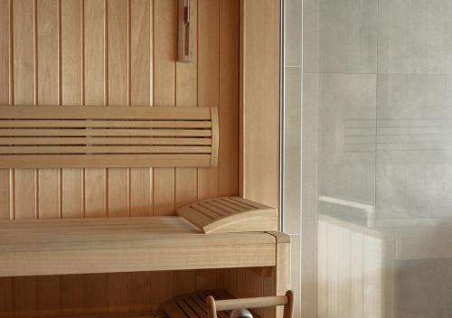a sauna with a wooden shelf and a glass shower at Nicosia Central Park Residences in Nicosia