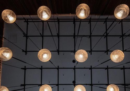 a bunch of lights hanging from the ceiling at Nicosia Central Park Residences in Nicosia