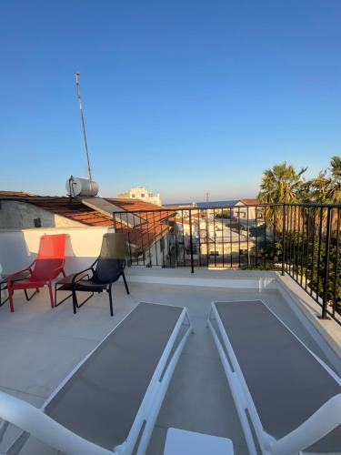 a balcony with a table and chairs on a roof at Le Voyageur By the Sea - Furnished Rooms in Larnaka