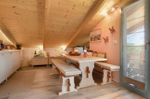 a dining room with a table and benches at Zante Villa Amici Loft in Laganas