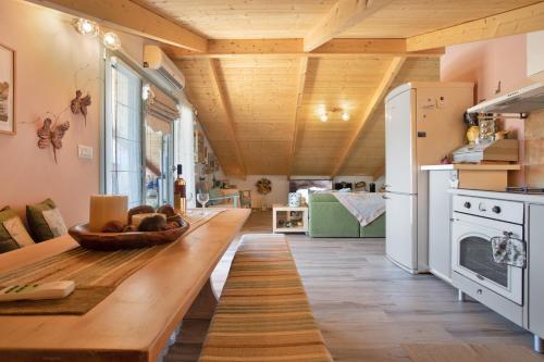 a kitchen with a long wooden table in a room at Zante Villa Amici Loft in Laganas