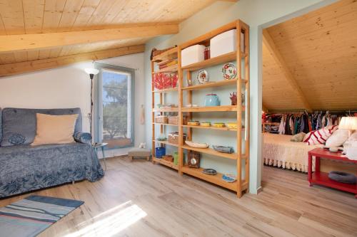 a room with a bed and a book shelf at Zante Villa Amici Loft in Laganas