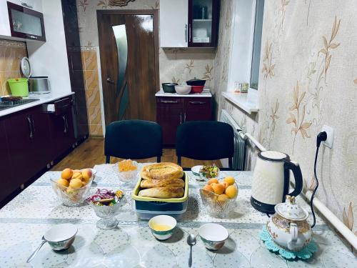 a kitchen with a table with food on it at SIA Guest House in Naryn