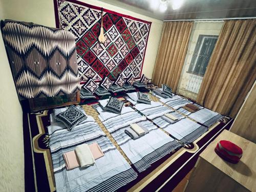 a bedroom with a bed with quilts on it at SIA Guest House in Naryn