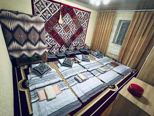 a bedroom with a bed with a quilt on it at SIA Guest House in Naryn