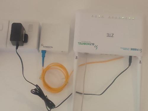 a white sewing machine with a cord plugged into it at River Valley in Weligama